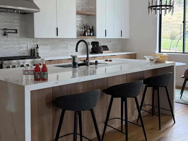 Clean modern kitchen with an island and bar stools